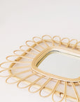 Rectangle shaped mirror with a piped rattan design.