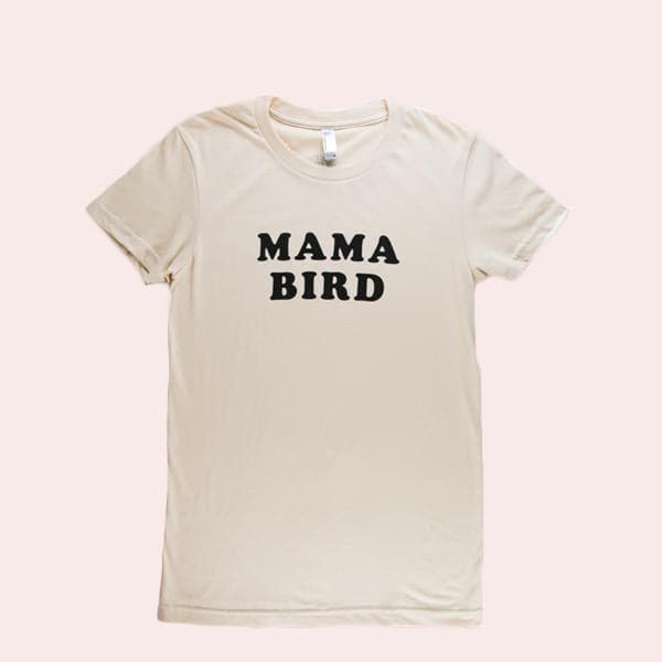 A cream cotton t-shirt with black letters across the from that read, &quot;Mama Bird&quot;.
