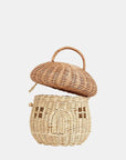 A natural colored rattan mushroom house basket with a handle on the top, a little arched door and square windows.