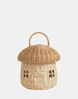 A natural colored rattan mushroom house basket with a handle on the top, a little arched door and square windows.