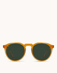 In front of a white background is a pair of round, orange sunglasses with green lenses.