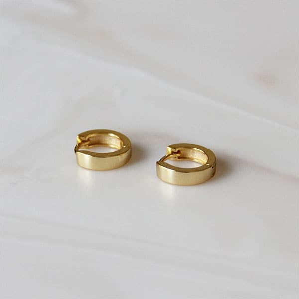 The perfect stacking huggie earring. Slightly thicker than the classic huggie but still simple enough to wear daily!
