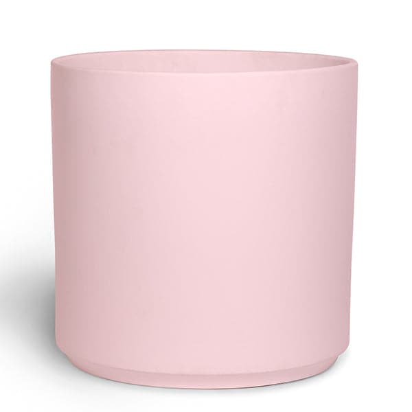 This cylinder ceramic pot is soft pink and is large enough to house a 7 gallon nursery pot.