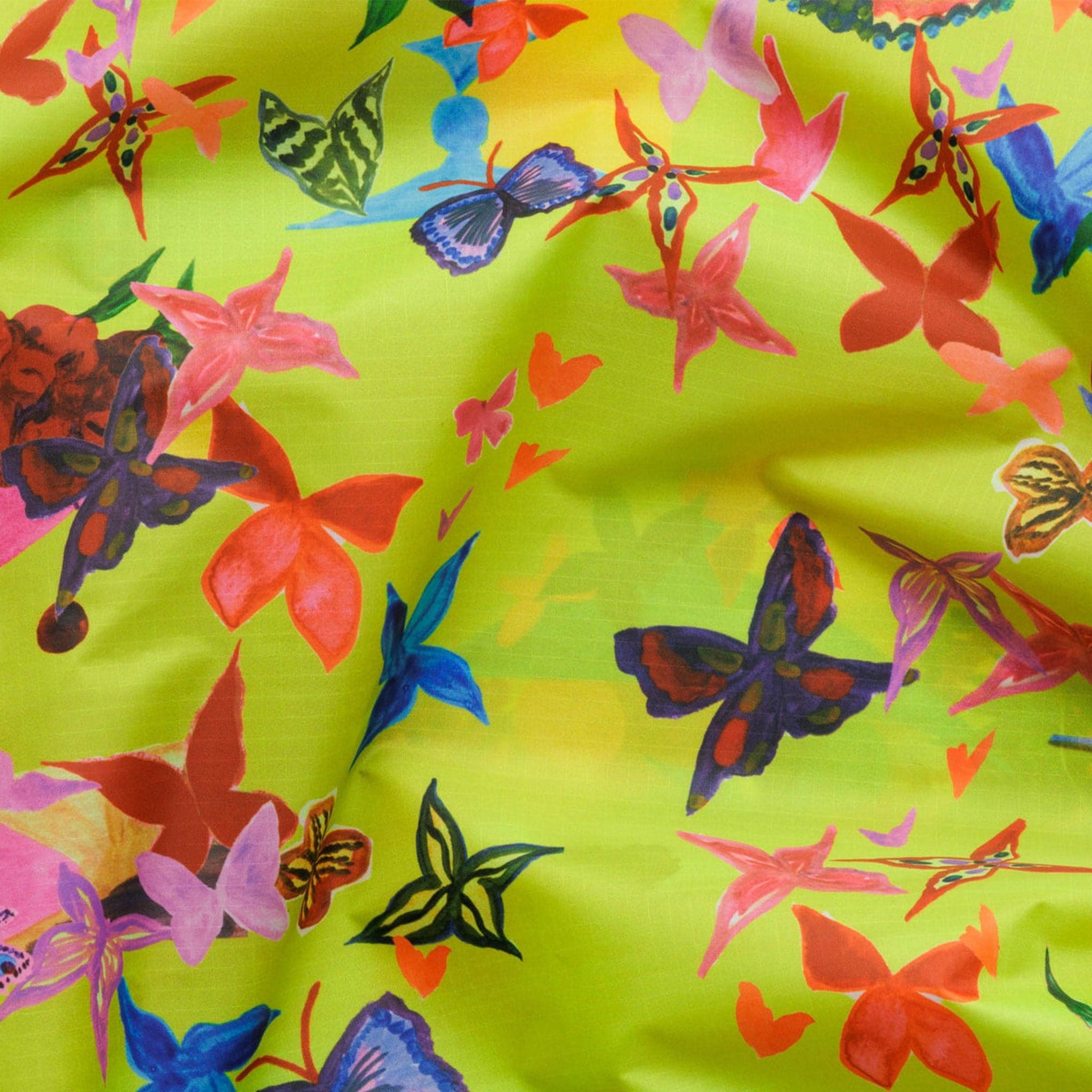 A reusable bag in a lime green shade with an assortment of different colored butterflies.