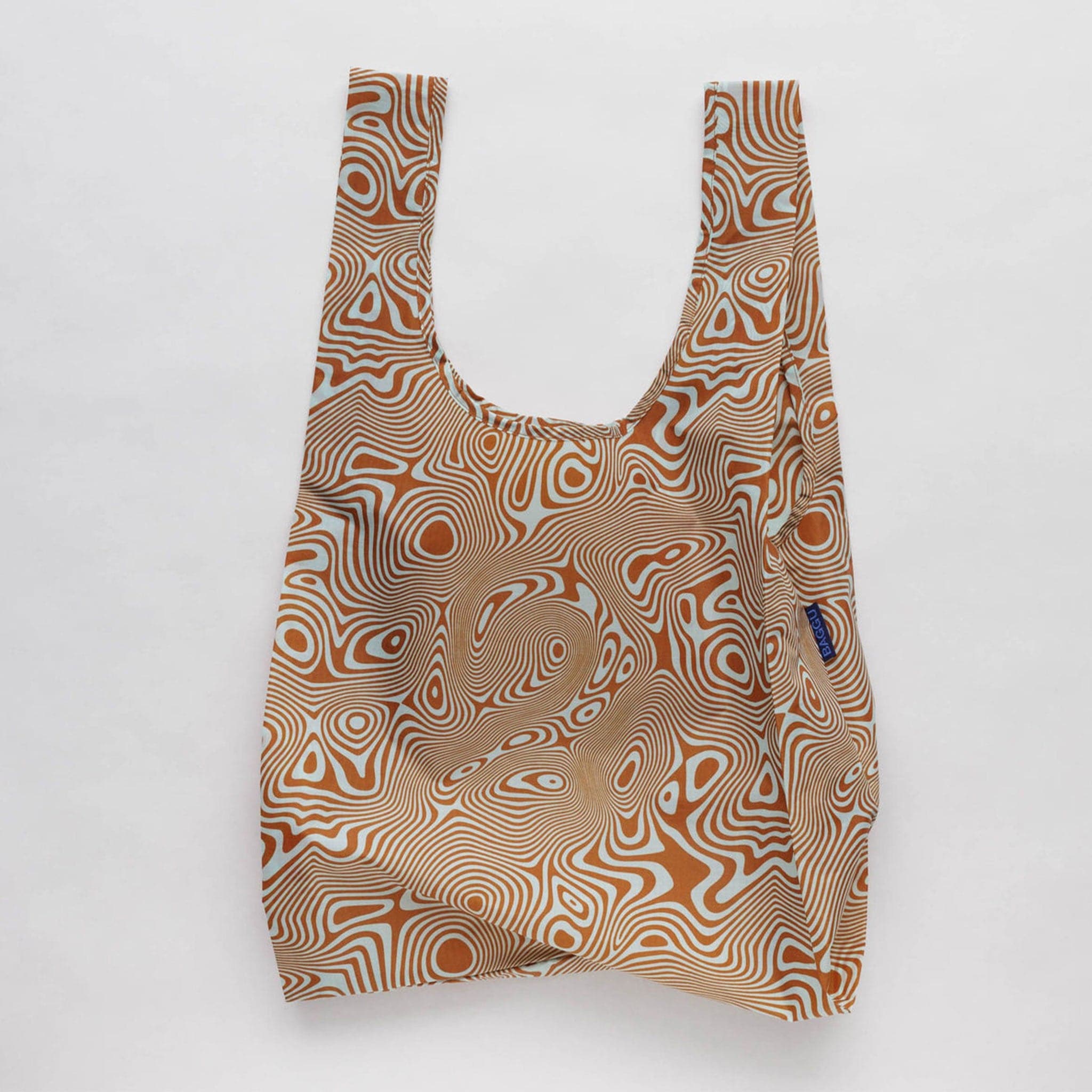 A nylon bag with an orange and cream wavy swirl pattern all over. 