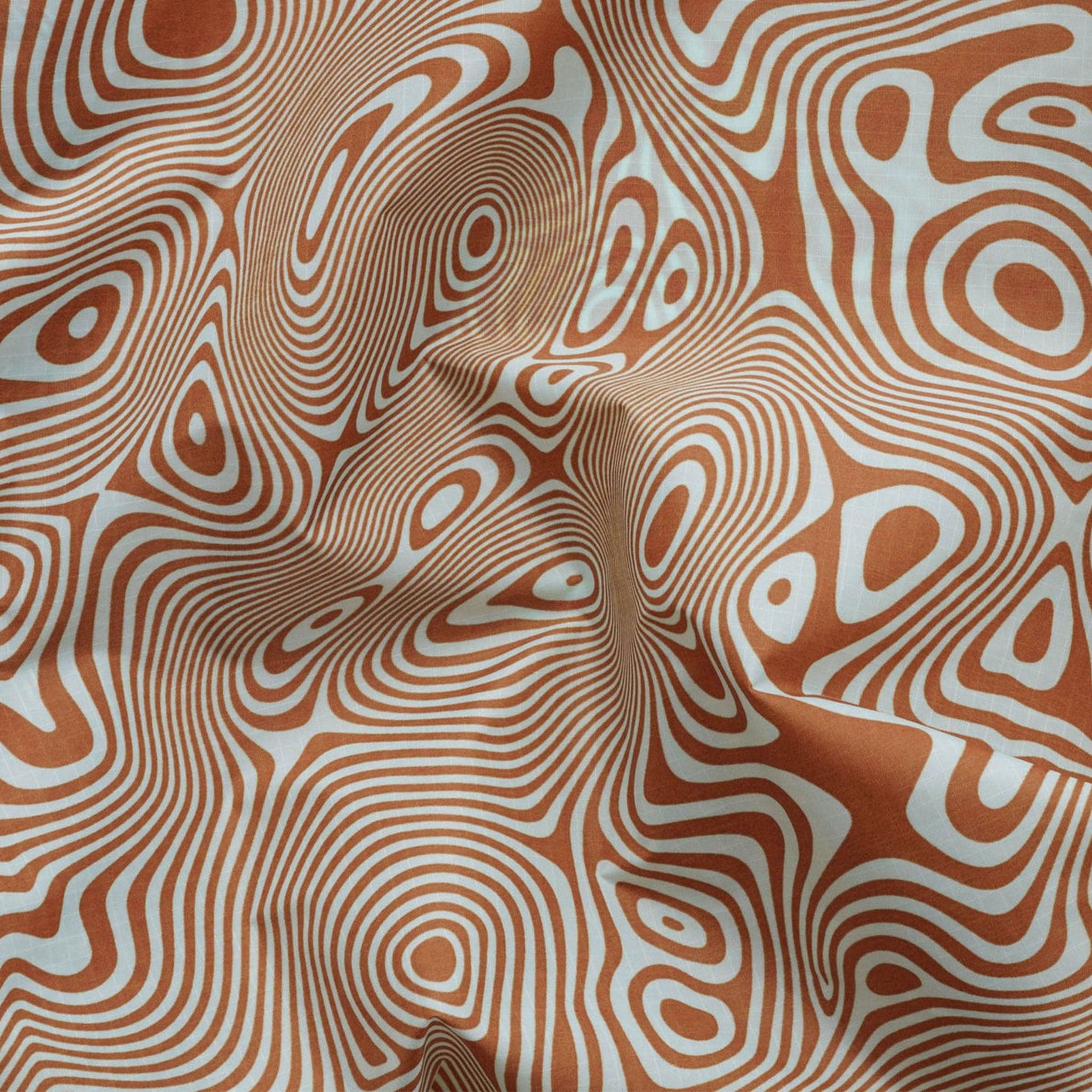 A nylon bag with an orange and cream wavy swirl pattern all over.