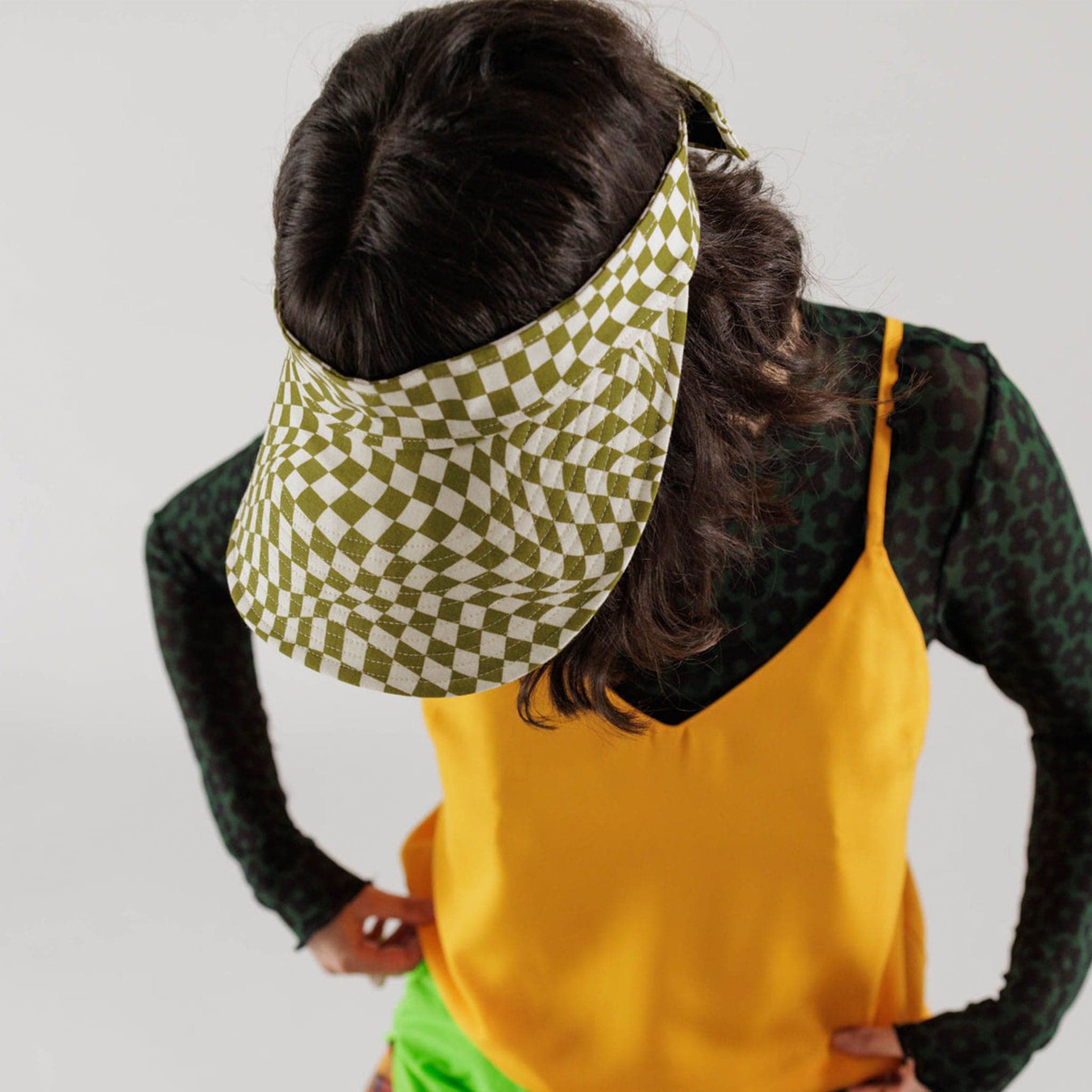 The green and white wavy checkered visor is shown here on a model.