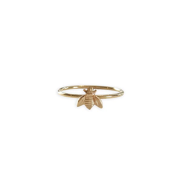  A dainty thin gold band ring with a small gold bee in the center.