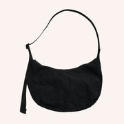 A nylon crescent shoulder bag with an adjustable strap and a single zipper. The interior also features a zipper for optimal organization.