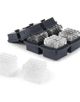 A dark grey silicone ice tray that makes large cubes with diamond detailing.