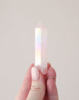 A rose quartz crystal with an iridescent quality to it.