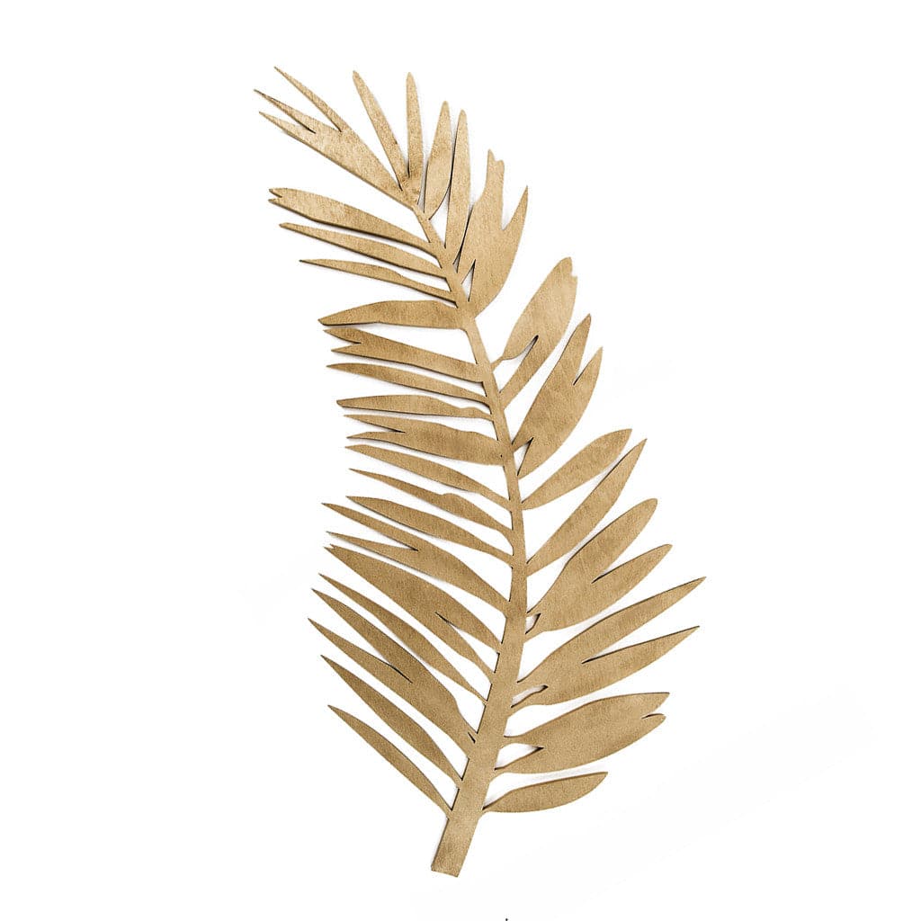 On a white background is a wooden cut out of a curved palm leaf. 