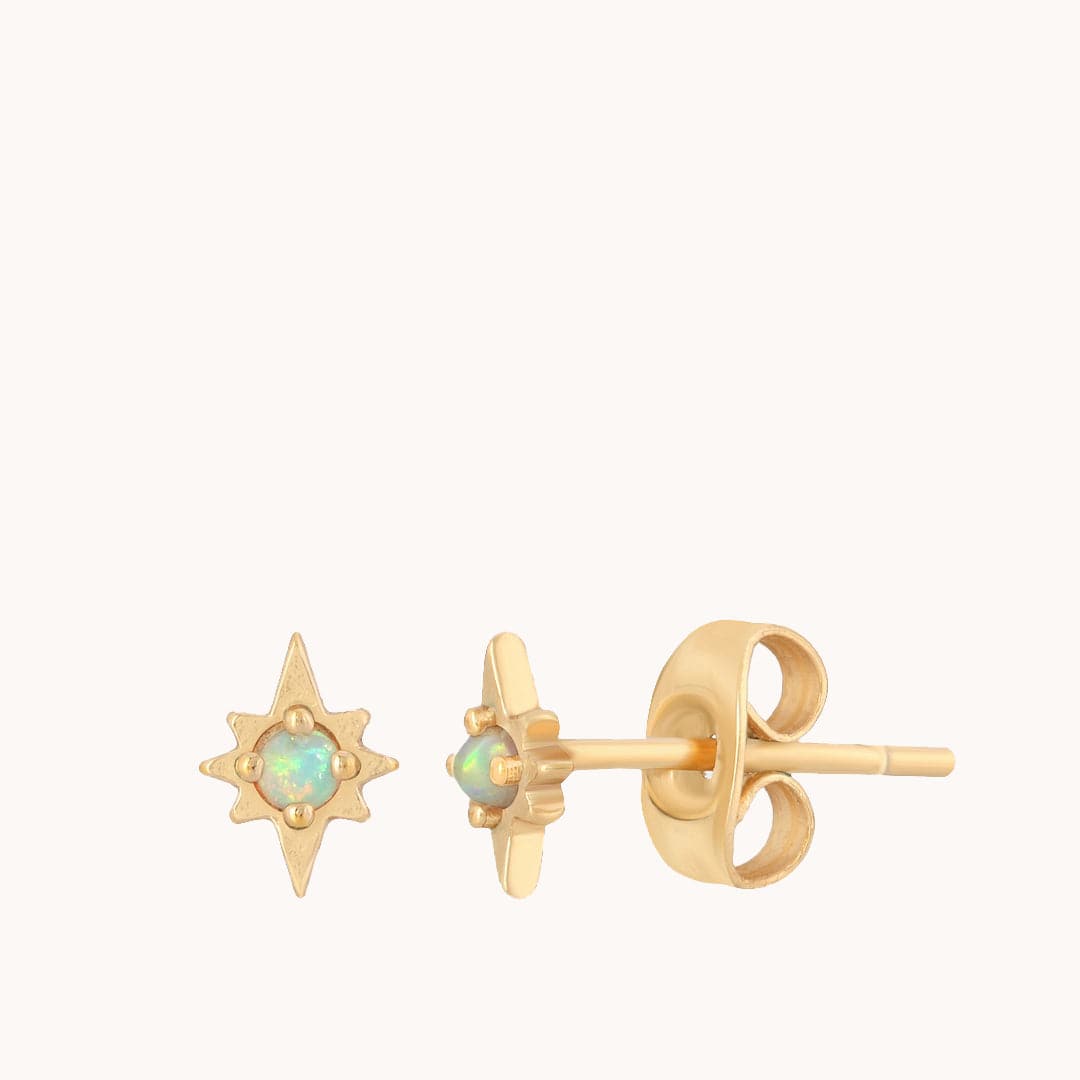 These starburst shaped stud earrings have 8 points and an opal center. They are gold plated brass and have classic round earring backs.