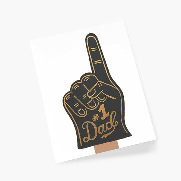 A white greeting card with a graphic of a black foam finger holding up number one along with gold accent text that reads, "#1 dad".