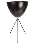In front of a white background is a black colored bullet planter. The planter has a wide top and narrows at the bottom. The planter is held up by a black metal stand. The stand has three black metal legs.