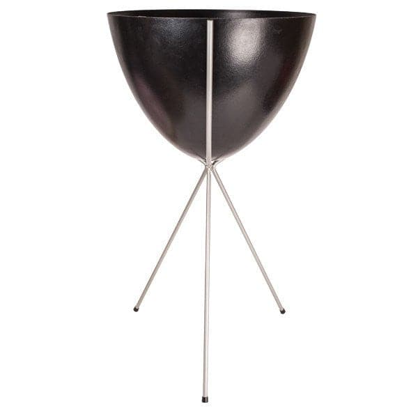 In front of a white background is a black colored bullet planter. The planter has a wide top and narrows at the bottom. The planter is held up by a silver metal stand. The stand has three silver metal legs.