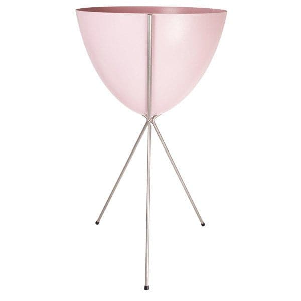 In front of a white background is a pink colored bullet planter. The planter has a wide top and narrows at the bottom. The planter is held up by a silver metal stand. The stand has three silver metal legs.