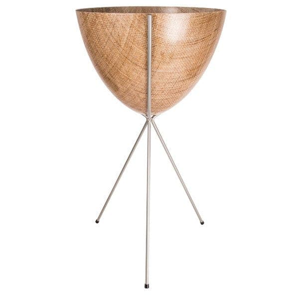 In front of a white background is a wood colored bullet planter. The planter has a wide top and narrows at the bottom. The planter is held up by a silver metal stand. The stand has three silver metal legs.