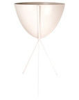 In front of a white background is a white colored bullet planter. The planter has a wide top and narrows at the bottom. The planter is held up by a white metal stand. The stand has three white metal legs.