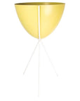 In front of a white background is a yellow colored bullet planter. The planter has a wide top and narrows at the bottom. The planter is held up by a white metal stand. The stand has three white metal legs.