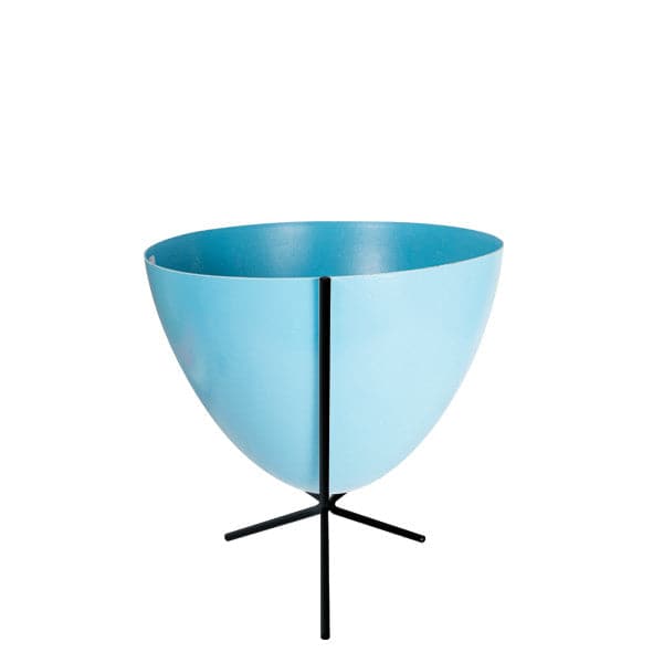 In front of white background is a bright blue planter in a short black metal stand. The bullet planter is wide at the top and narrow at the bottom. The metal stand has three legs.