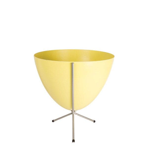 In front of white background is a yellow planter in a short silver metal stand. The bullet planter is wide at the top and narrow at the bottom. The metal stand has three legs. 