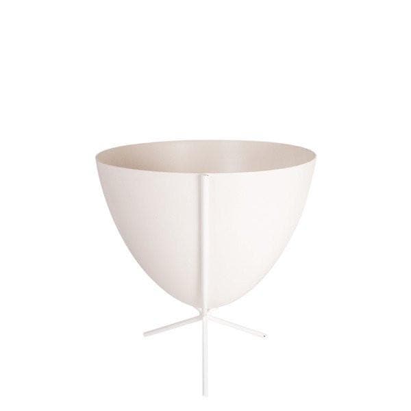 In front of white background is a white bullet planter in a short white metal stand. The bullet planter is wide at the top and narrow at the bottom. The metal stand has three legs. 