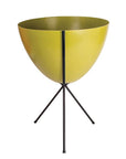 In front of white background is an olive green planter in a black metal stand. The bullet planter is wide at the top and narrow at the bottom. The metal stand has three legs.