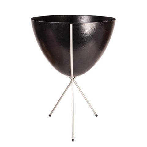 In front of white background is a black planter in a silver metal stand. The bullet planter is wide at the top and narrow at the bottom. The metal stand has three legs. 