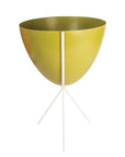 In front of white background is an olive green planter in a white metal stand. The bullet planter is wide at the top and narrow at the bottom. The metal stand has three legs.