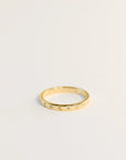 Delicate gold ring with etched suns and moons circling the band. Each sun and moon has a CZ gem in the center.