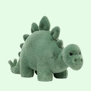 On a white background is a green stegosaurus stuffed animal.