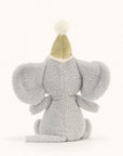 Soft stuffed animal in the shape of a dove grey animal wearing a pompommed party hat tied with satiny ribbon