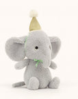 Soft stuffed animal in the shape of a dove grey animal wearing a pompommed party hat tied with satiny ribbon