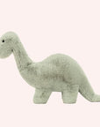 On a white background is a green brontosaurus stuffed animal.