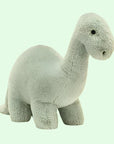 On a white background is a green brontosaurus stuffed animal.