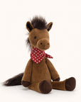 Soft stuffed animal in the shape of a brown horse with fluffy dark brown mane and tail, and wearing a red and white spotted bandana around its neck.