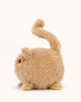 Soft stuffed animal in the shape of a round caramel colored cat with a question mark shaped tail.
