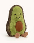A sweet stuff little green avocado with a friendly smile and cord legs. This avocados skin is dark green and had a light green color for the inside. Showing on its tummy is a little brown avocado seed.