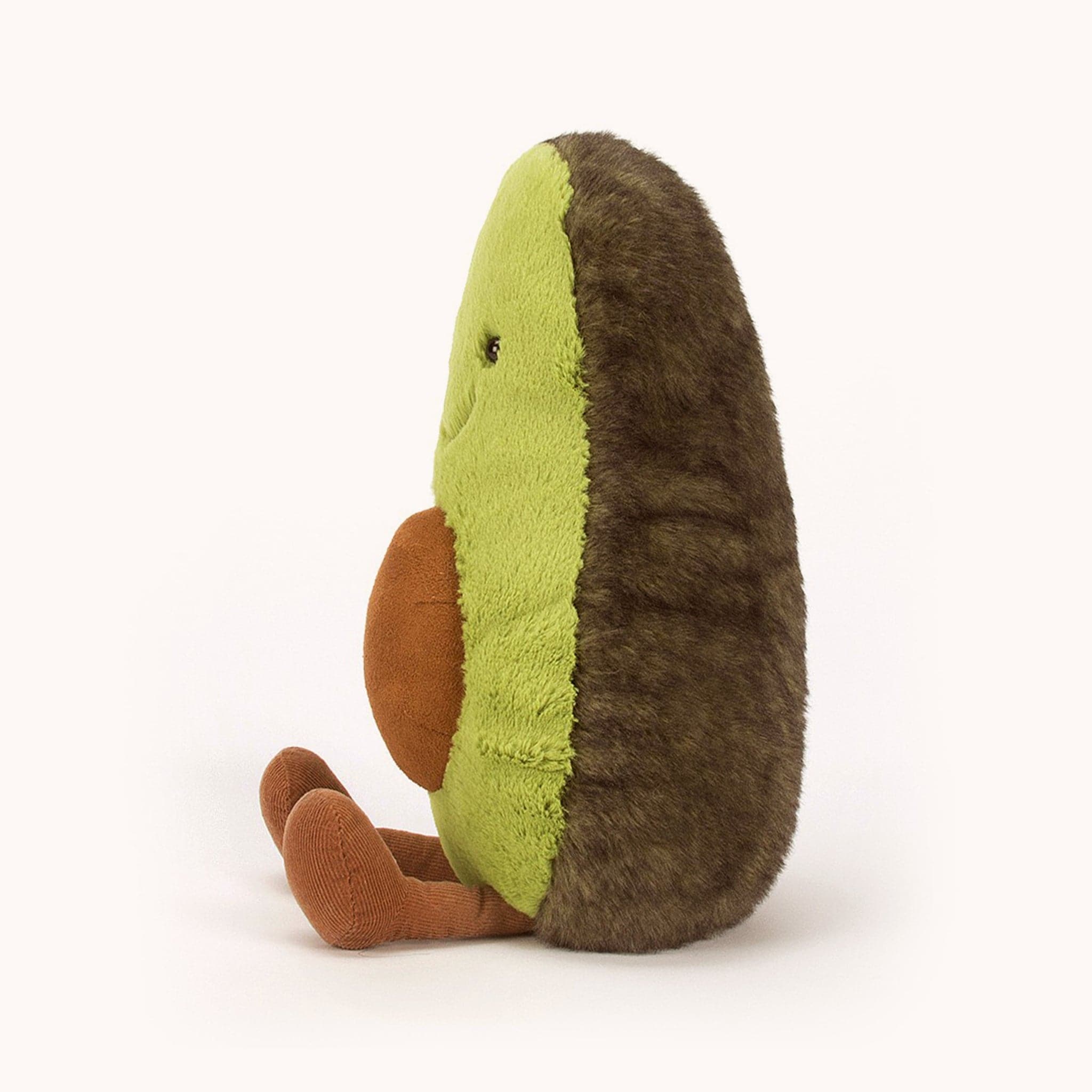 A sweet stuff little green avocado with a friendly smile and cord legs. This avocados skin is dark green and had a light green color for the inside. Showing on its tummy is a little brown avocado seed.
