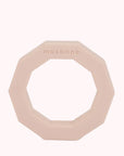 A decagon ring shaped rubber dog toy in light peachy color.