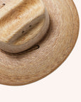 A darker brown straw sun hat with a wide curved brim and a drawstring.
