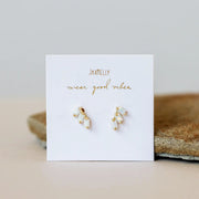 Three dainty baguette set white opals slope delicately down off one another, giving off a major art deco mood.
