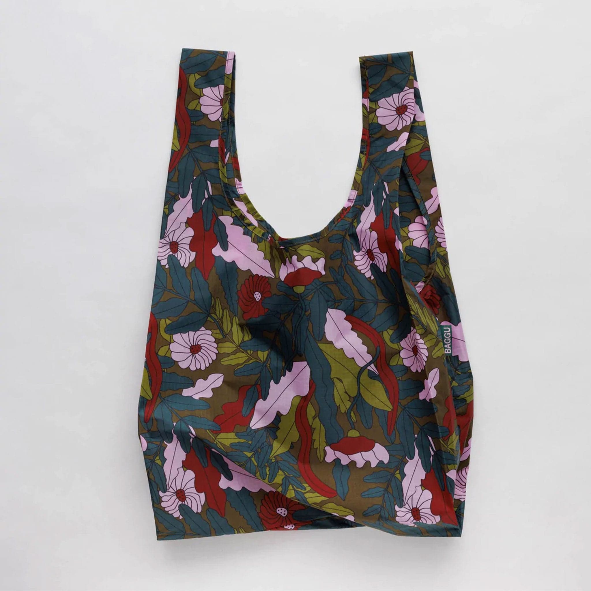 A dark green bag with leaves and flowers that range from lavender tones to dark reds and greens.