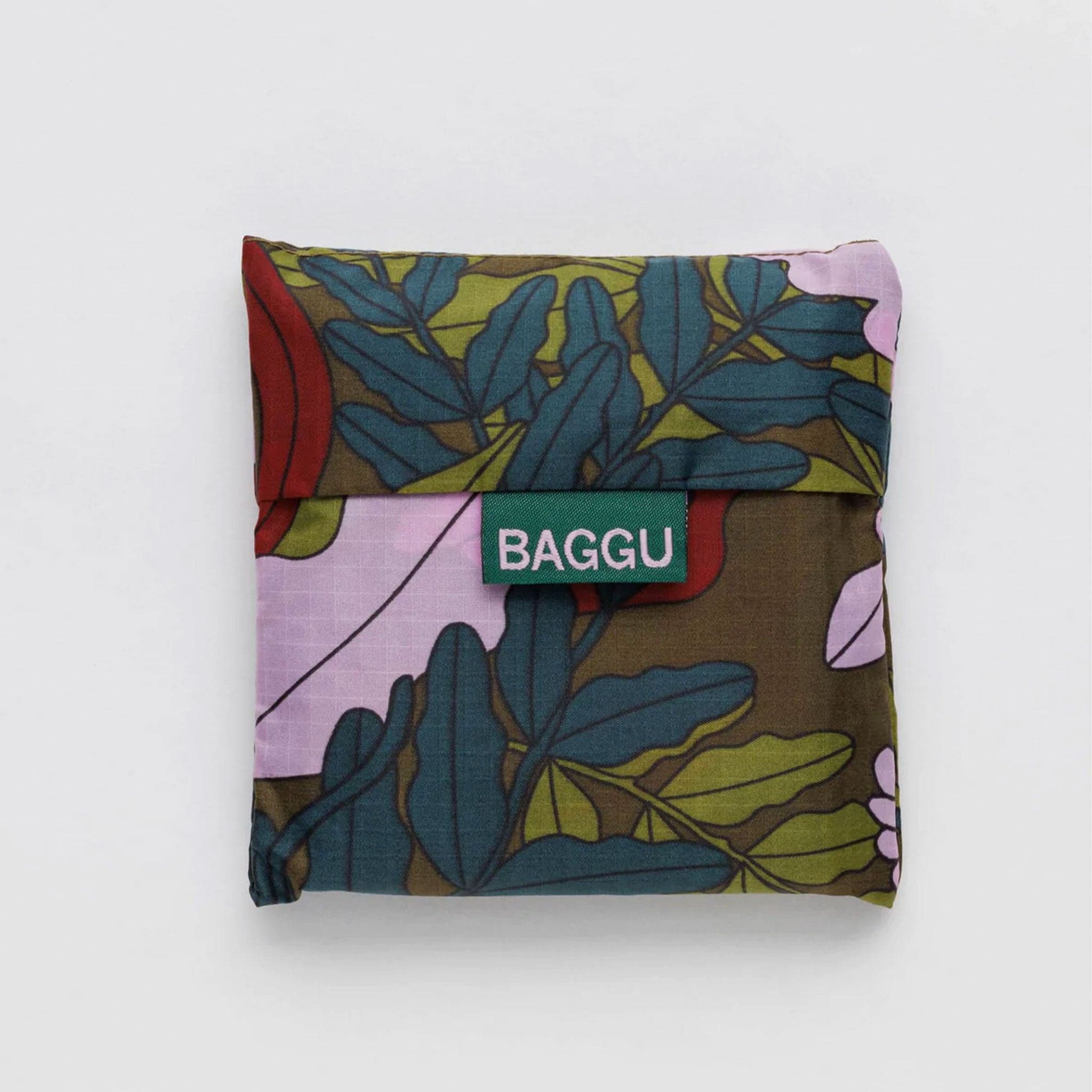 A dark green bag with leaves and flowers that range from lavender tones to dark reds and greens.