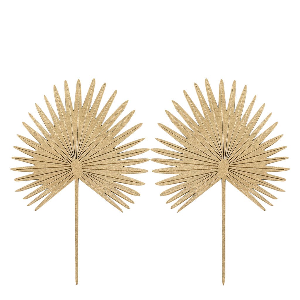 In front of a white background are two wood palm cut outs. They both have a long stem and a fan out palm leaf.
