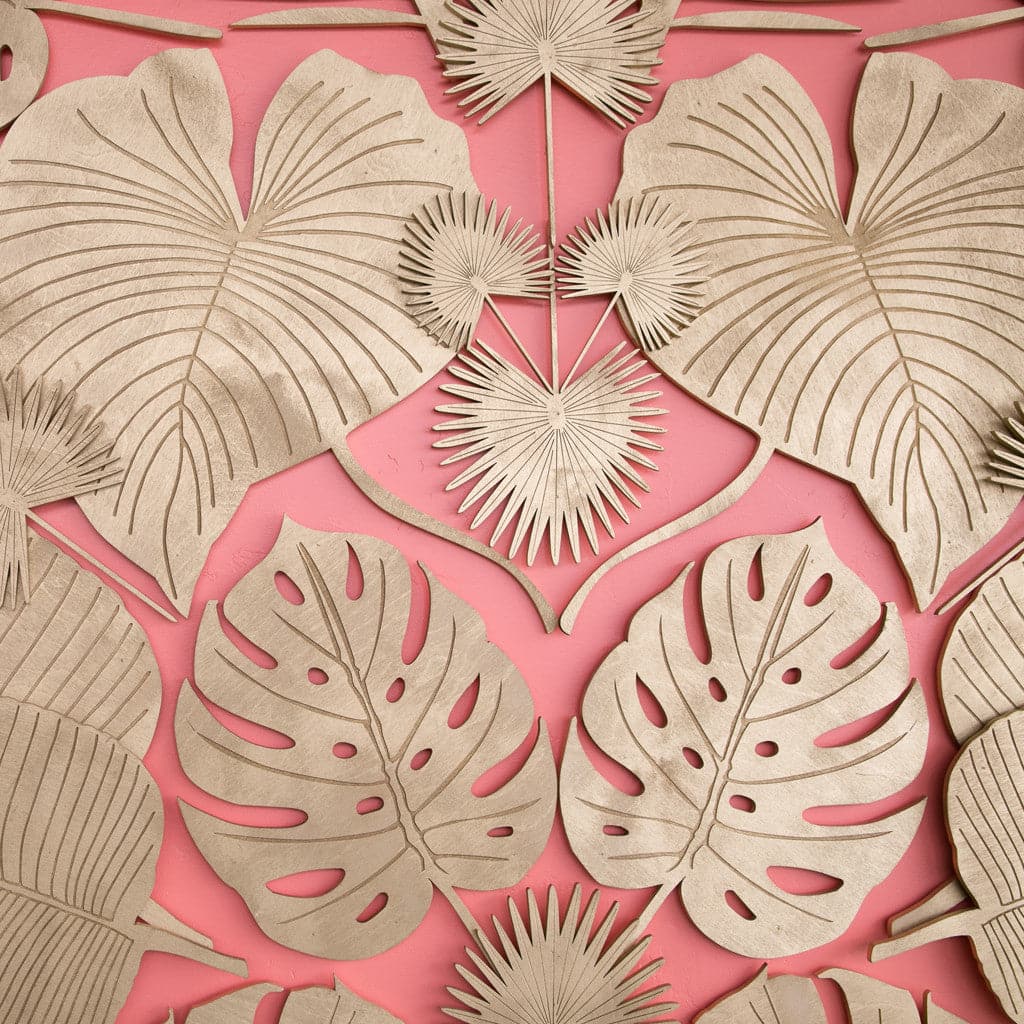 A wooden Monstera Leaf cut out photographed here with other cut outs featuring different leaf designs. 