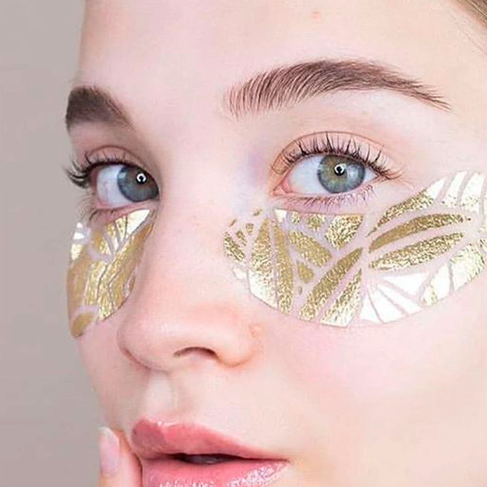 The gold eye patches worn on a model&#39;s under eyes.