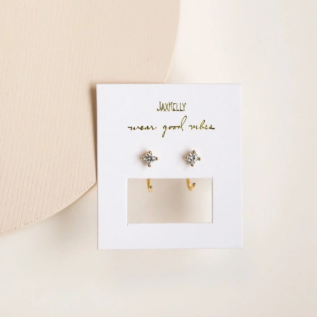 Gold huggie earrings with a CZ stone. Loop the non-stone end through like you would a normal post, and let these dainty earrings hug your ear tight