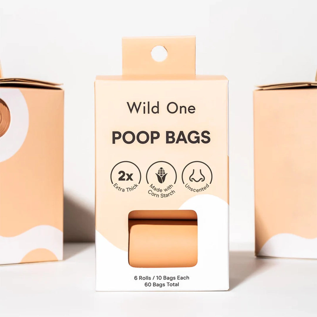 A box of 6 rolls of poop bags in a salmon orange color along with black text that reads, "Wild One Poop Bags".